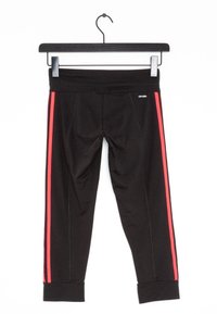 Svarta atletiska leggings med röda sidostråk, med hög midja och manchetter i nederkant. Tillverkade av stretchigt, slätt material.