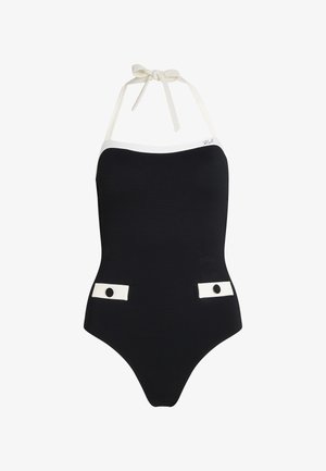 Bañador de una pieza negro con una tela texturizada, acentos blancos en el escote y los lados, y tirantes de lazo en la parte posterior.