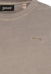 Beige sweatshirt med rund hals og ribbede ærmer og kant. Har broderet "Schott" logo i lyse beige. Fremstillet af blødt, tekstureret stof.