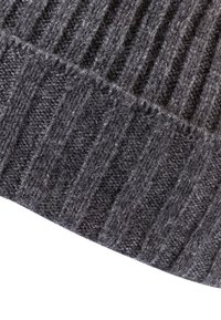 Dark gray knitted fabric with vertical ribbed texture, showing detailed stitch patterns and soft, fuzzy fibers.