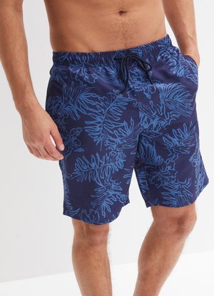 Shorts de bain bleu marine avec un motif de feuilles tropicales bleues, taille élastique et fermeture à cordon. Fabriqués en tissu léger.