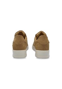 Sneaker in suede marrone con finitura texturizzata, suola in gomma bianca e collo imbottito. La vista posteriore mostra cuciture minime e un design del tallone arrotondato.