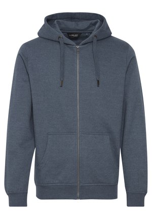 Tamna plava zip-up dukserica, napravljena od kombinacije pamuka. Ima kapuljaču s vezicom, prednje džepove i rebraste manžete i rub.