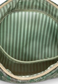 Zippered pouch opened to show green and gray vertical striped fabric lining and stitched interior pocket.