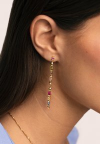 Pendientes colgantes de oro con diversas piedras preciosas de colores en formas rectangulares y triangulares, diseñados para colgarse elegantemente junto a la oreja.