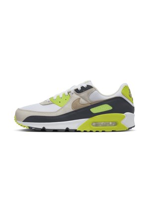 White and beige Nike Air Max sneaker with black and neon green accents, visible air cushion in the sole, and white laces.