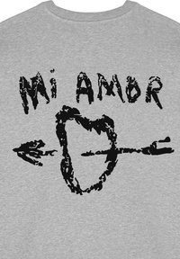 Felpa grigia con audace testo nero "Mi Amor" sopra una forma di cuore trafitta da una freccia. Il testo e il grafico presentano una texture vissuta.