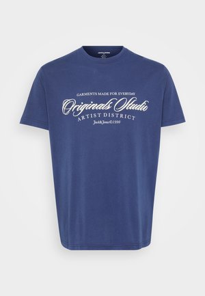 Navy blue cotton t-shirt with short sleeves, round neckline, and white graphic text reading "Original Studio Artist District" on the front.