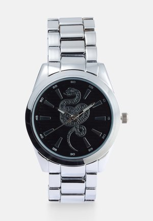 Silver stainless steel watch with a round black dial featuring a snake design, hour markers, and a metallic link bracelet.