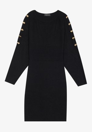 Vestido negro de tela suave, con mangas largas y acentos de botones dorados en los hombros, y una silueta ajustada.