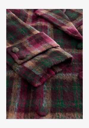 Wollen geruite jas met een mix van bordeauxrood, groen en bruin tinten, een gestructureerde afwerking, een oversized kraag en knoopdetail bij de manchetten.