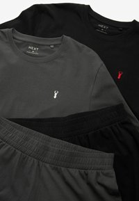 To skjortearmede t-shirts, en sort og en mørkegrå, med små broderede hummerlogoer; blødt stof med en glat tekstur.