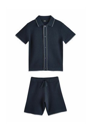 Navy two-piece outfit featuring a short-sleeved polo with white trim and buttons, paired with matching drawstring shorts. Textured fabric.