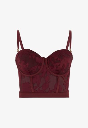 Soutien-gorge en dentelle florale bordeaux avec armatures, panneaux transparents et bretelles ajustables. Présente des accents décoratifs en métal doré sur les bretelles.