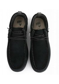 Scarpe in suede nere con punta arrotondata, cuciture bianche a contrasto e lacci elastici. Interno foderato per il comfort. Marchio Pitas sulla soletta.