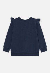 Felpa blu navy con maniche lunghe, polsini e orlo a coste, caratterizzata da dettagli in pizzo sulle spalle, realizzata in tessuto morbido e leggero.