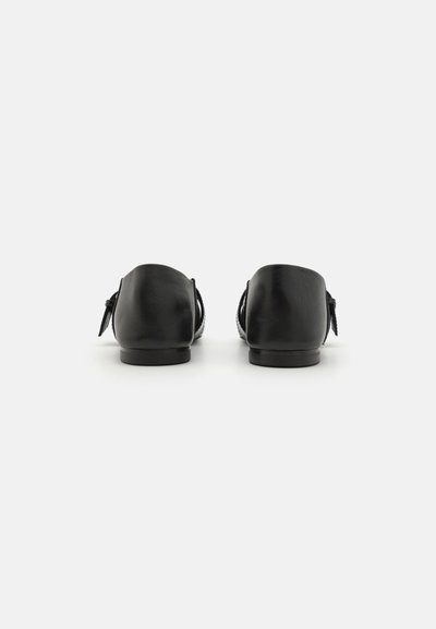 Black leather shoes with a rounded toe and low heel, featuring a smooth texture and subtle back bow detail.