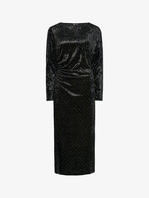Schwarzes Samtkleid mit langen Ärmeln, tailliertem Oberteil und geradem Rock. Geschmückt mit silbernen funkelnden Punkten über das gesamte Kleid. Seitliche Raffung.