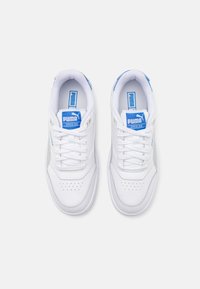 White athletic sneakers with a smooth synthetic upper, blue accents, textured tongue, and perforated detailing on the toe box.