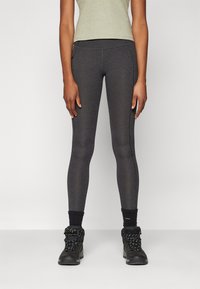 Dark gray leggings with a smooth texture, featuring a high waistband and contrasting seam detail, paired with sturdy black hiking boots.