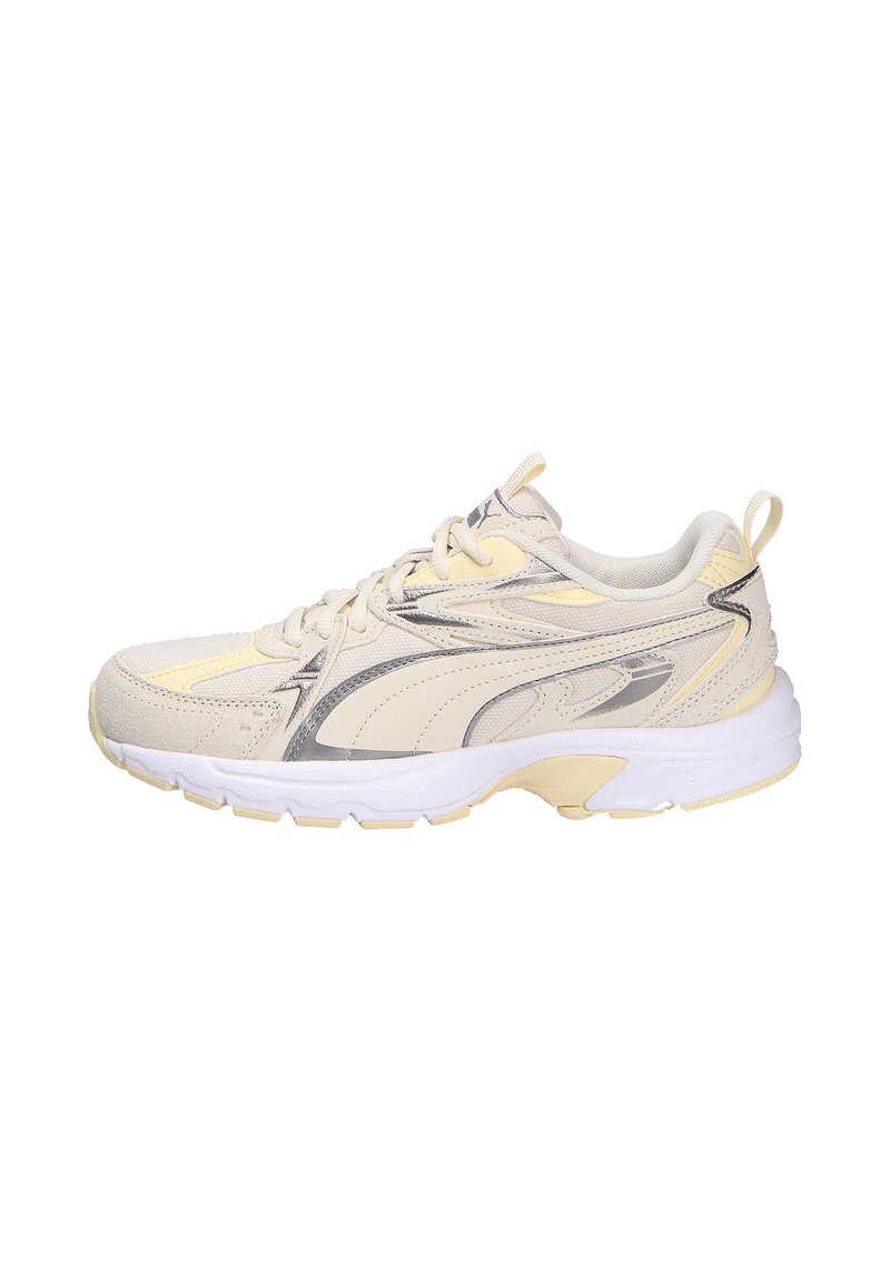 Light beige athletic shoe with a textured upper, silver accents, and a white midsole. Features laces and a pull tab at the heel.