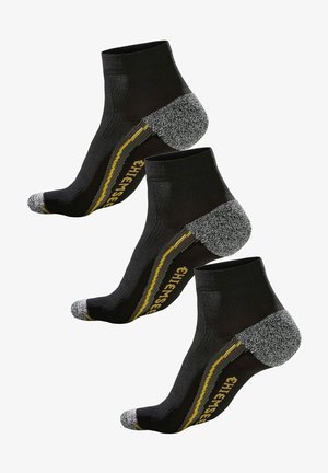 Schwarze Knöchelsocken mit grauen und gelben Akzenten, ausgestattet mit einer strukturierten Ferse, verstärktem Zehenbereich und geripptem Design für eine gute Passform und Komfort.