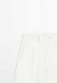 White high-waist trousers with belt loops, side pockets, front button, and zip fly closure on a plain background.