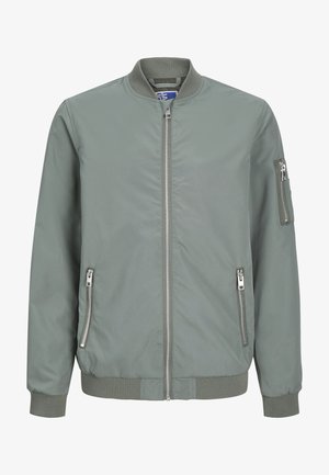 Giacca bomber verde con zip frontale, tasche laterali e tasca con zip sul braccio. Tessuto liscio con polsini e orlo a costine.