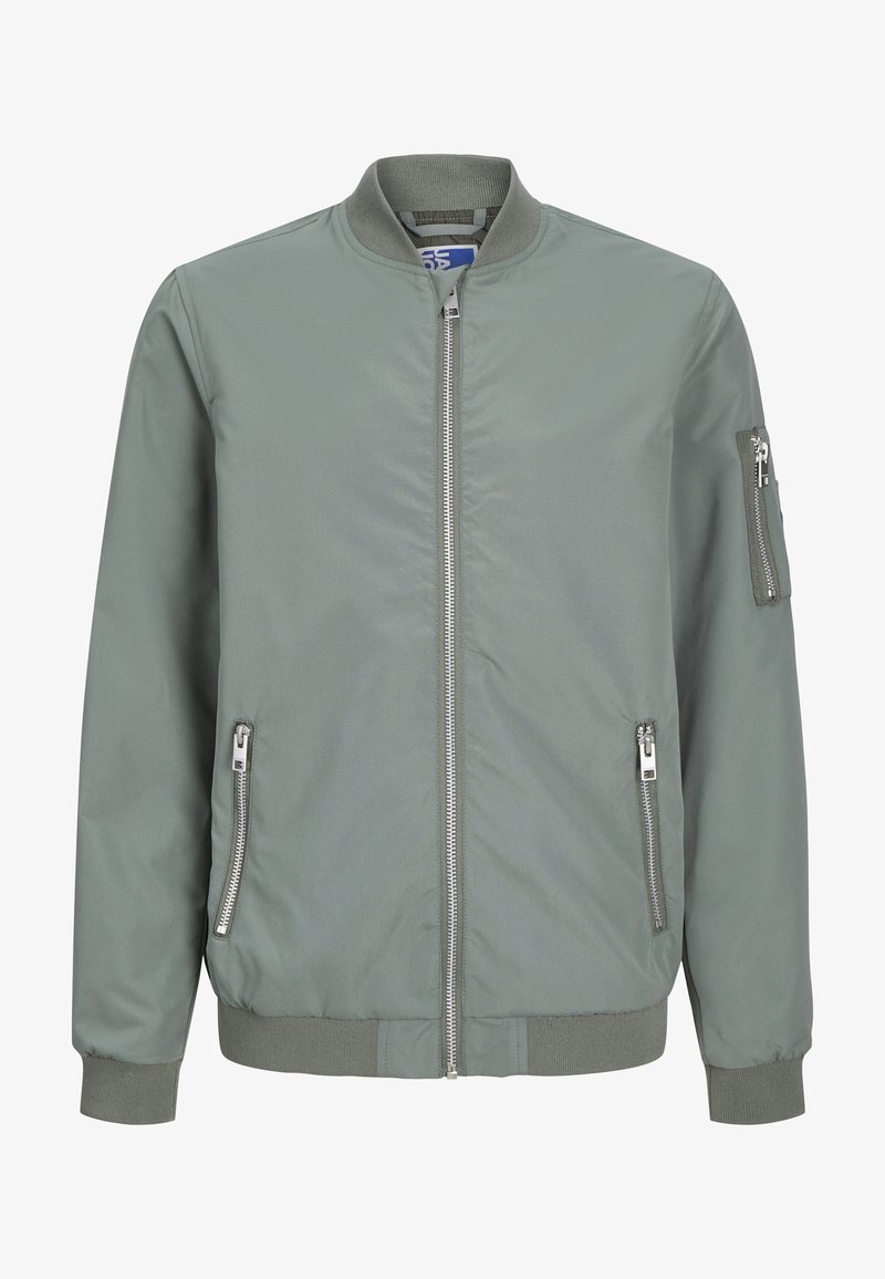Veste bomber verte avec fermeture éclair à l'avant, poches latérales et poche zippée sur le bras. Texture lisse avec des poignets et un ourlet côtelés.