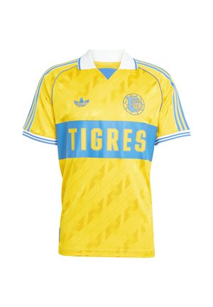 Geel voetbalshirt met blauwe horizontale streep, bevat de tekst "TIGRES", geborduurd logo en gestreepte schouderaccenten. Gemaakt van gladde stof.