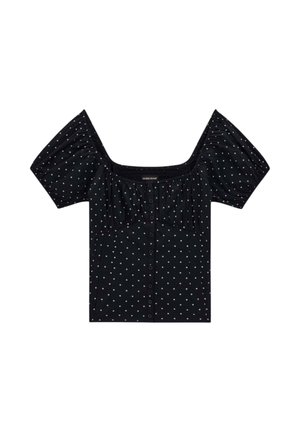 Blusa nera a maniche corte con pois bianchi, scollo quadrato, arricciatura frontale e bottoni al centro.