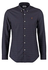Granatowa koszula z długim rękawem, z przyciskiem i małymi czerwono-białymi grochami, o klasycznym kołnierzyku. Posiada haftowane logo na piersi.