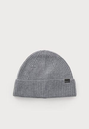Gray knitted beanie with ribbed texture, featuring a folded cuff and a small black logo tag on the side. Classic round shape.