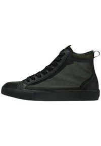 Svarta högstövlar i sneakerstil har en ovandel av mesh och gummisula, med snörning, rund tå och en dragflik på baksidan.