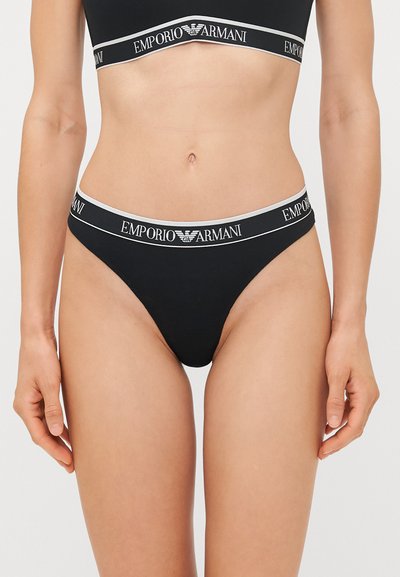 Zwarte onderbroek met een brede tailleband met het "EMPORIO ARMANI" logo in het wit, van zacht katoen en met een minimalistisch ontwerp.