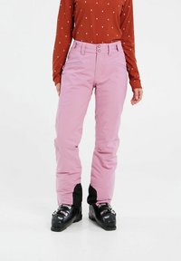Ružové lyžiarske nohavice so strmom strihom, ktoré majú čierne akcentové panely na členkoch. Tkanina je hladká a odolná, vhodná na zimné športy.