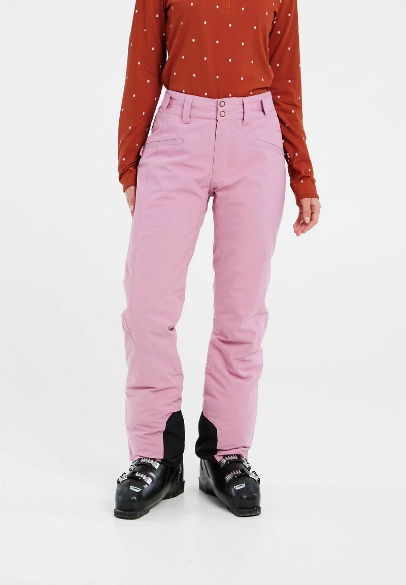 Ružové lyžiarske nohavice so strmom strihom, ktoré majú čierne akcentové panely na členkoch. Tkanina je hladká a odolná, vhodná na zimné športy.