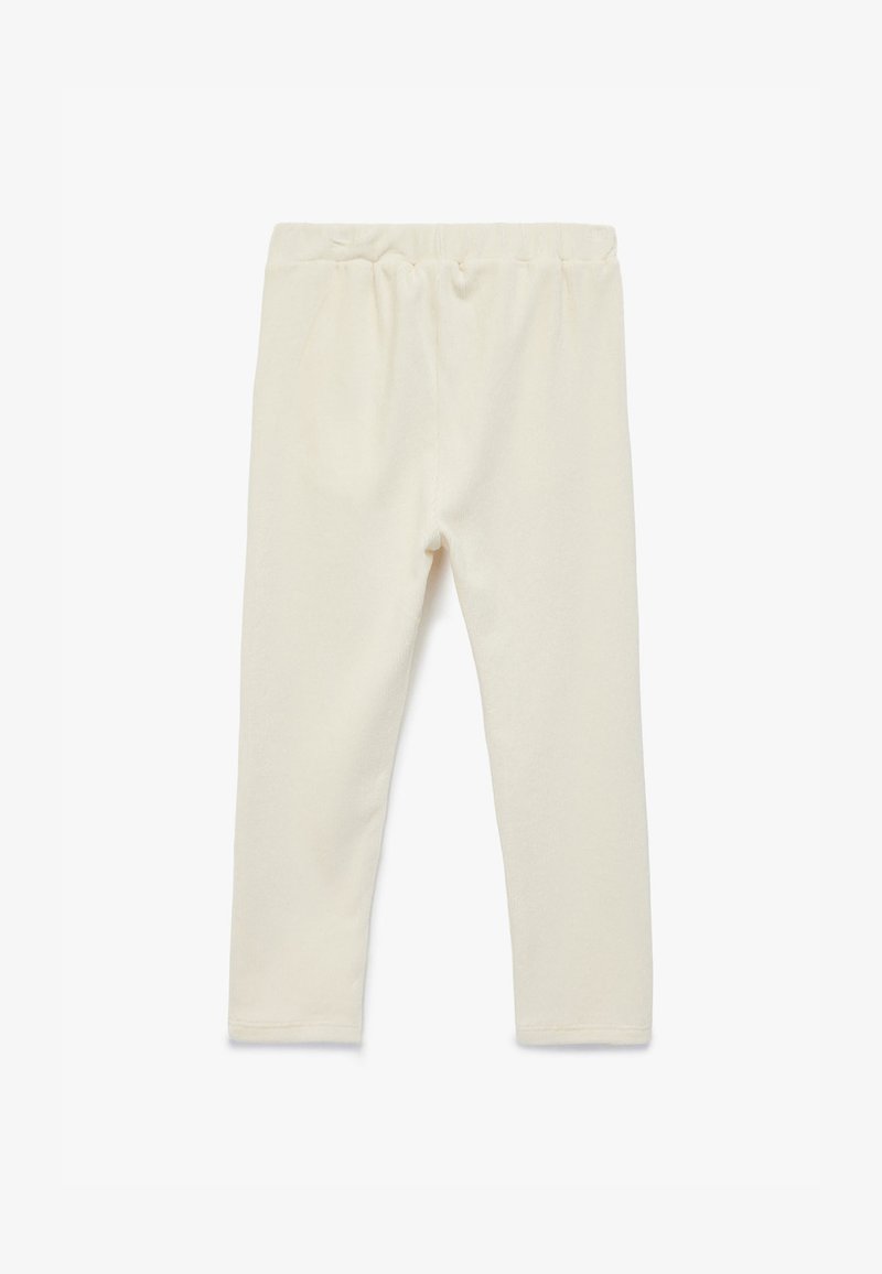Blege leggings med elastisk talje, lavet af blødt stof. Har en glat tekstur og tætsiddende design.