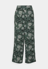Pantaloni a gamba larga in tessuto verde scuro, caratterizzati da un motivo floreale bianco e nero con foglie. Texture liscia, vita elastica e senza chiusure visibili.