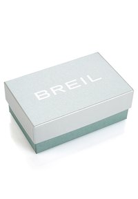 Scatola di cartone grigio chiaro con una finitura testurizzata, caratterizzata da un logo bianco "BREIL" sulla parte superiore e una base solida color teal. Forma rettangolare.