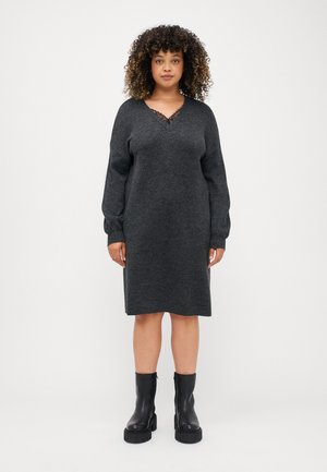 Knitted dark gray dress with a V-neck and lace detail, long sleeves, and a relaxed fit, paired with black ankle boots.