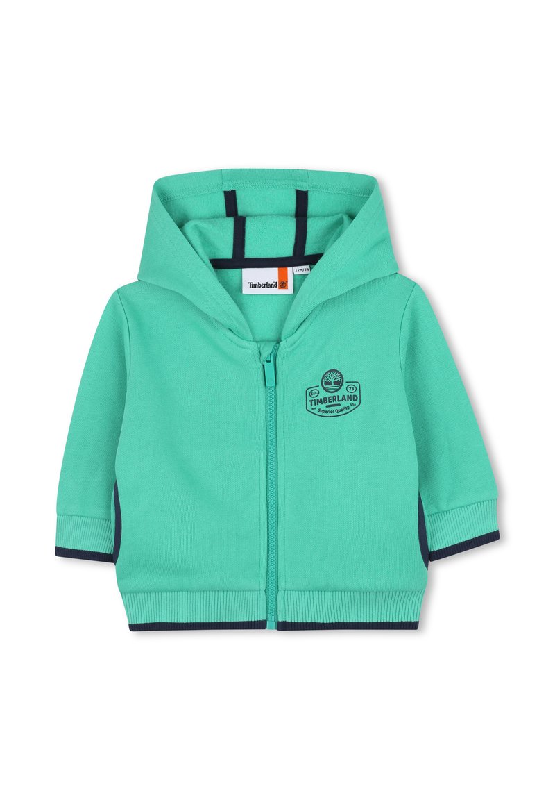Hoodie zippé vert menthe avec un accent bleu marine sur les poignets et les côtés. Présente un logo sur la poitrine et est fabriqué en coton doux.