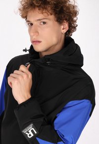 Schmuddelwedda urban rain - Chaqueta outdoor - schwarz königsblau colorblock