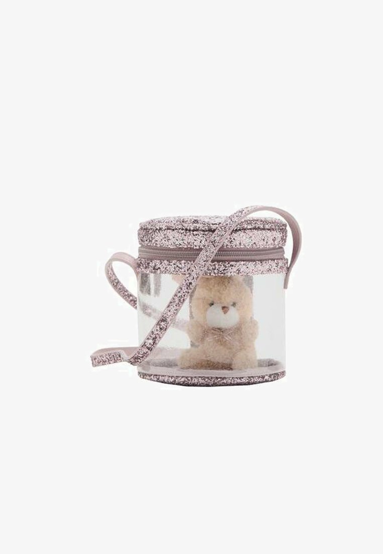 Przezroczysta okrągła torba z miękkim misiem w środku, różowe brokatowe akcenty i pasujący pasek. Teksturowana górna część z zamkiem błyskawicznym.