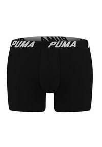Black boxer shorts with a snug fit, featuring a wide, elastic waistband with the "PUMA" logo in white lettering. Smooth fabric texture.