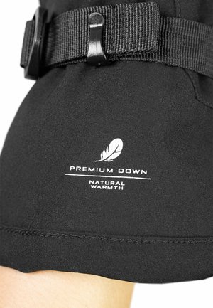 Black fabric with a smooth texture features white branding that reads “Premium Down” and “Natural Warmth” below a feather icon.