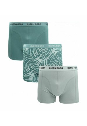 Drie Björn Borg herenboxershorts in verschillende tinten groen: effen donker, groen met bladmotief, en lichtgroen effen met merkbanden in de taille.