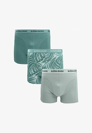 Drie Björn Borg herenboxershorts in verschillende tinten groen: effen donker, groen met bladmotief, en lichtgroen effen met merkbanden in de taille.