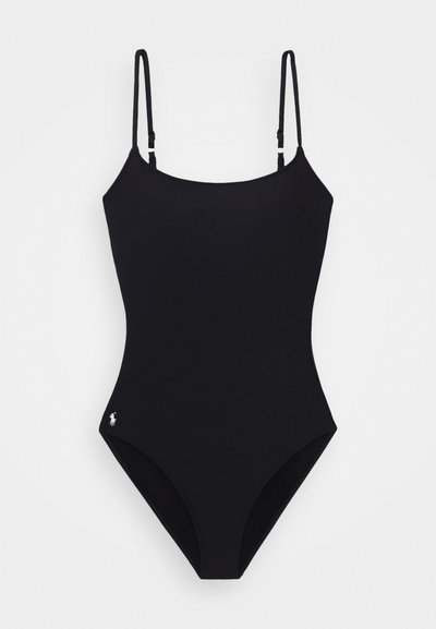 Black one-piece swimsuit with thin adjustable straps, a high-cut leg design, and a small logo accent on the left hip. Smooth fabric texture.