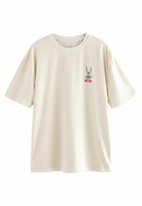 Helles, cremefarbenes Baumwoll-T-Shirt mit kurzen Ärmeln und rundem Ausschnitt. Auffälliges Grafikelement eines Cartoon-Hasen auf der Brust.